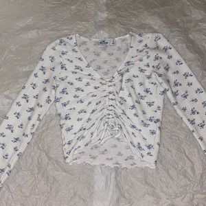 Hollister: Slightly cropped white and blue floral long sleeve top.